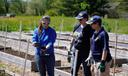 Garden of Health founder Carol Bauer and two other people at a farm.
